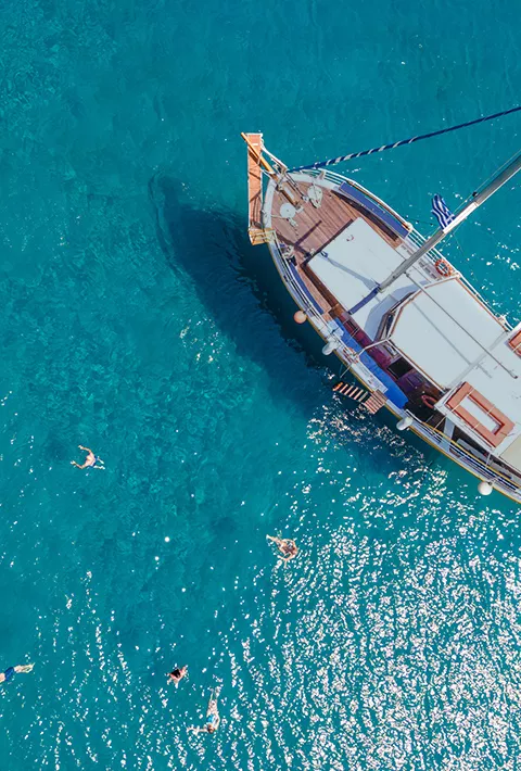 Aerial shot of a boat in the seas of Greece