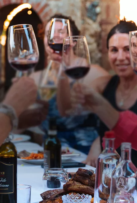 Toasting glasses of red wine