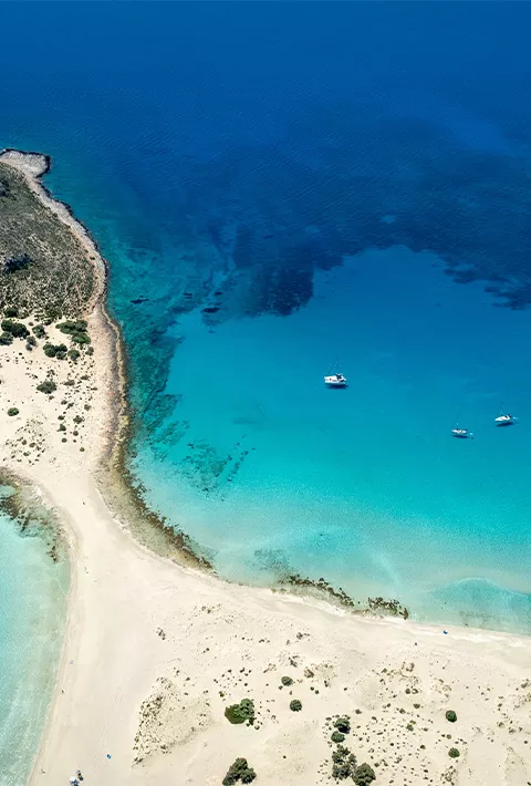 Aerial shot of a strip of beach between pools of water