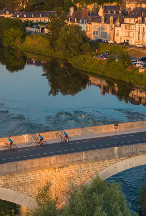 people biking across a bridge