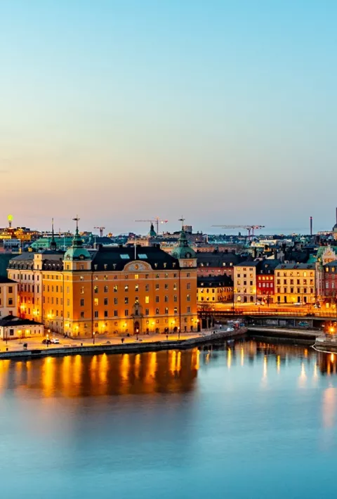 Aerial view of a city surrounded by blue water