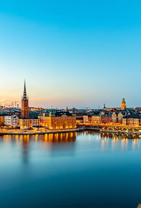 View of a city surrounded by clear blue water