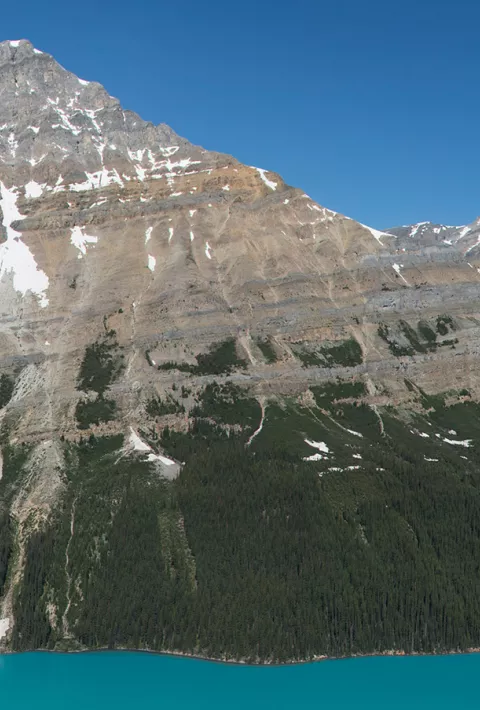 Mountain range in front of blue water