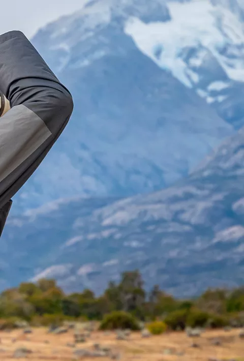 Man with a camera photographing a mountain