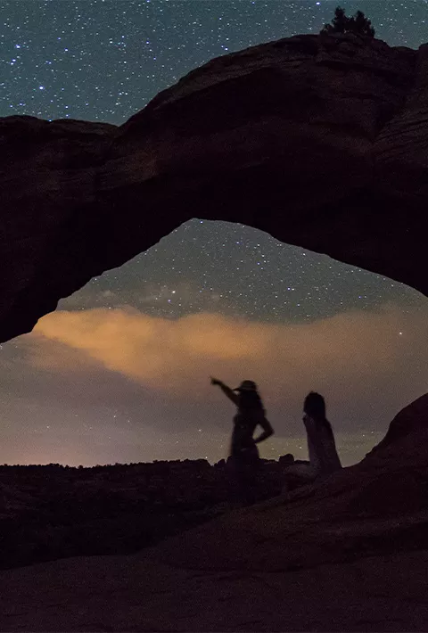 two silhouettes stargazing