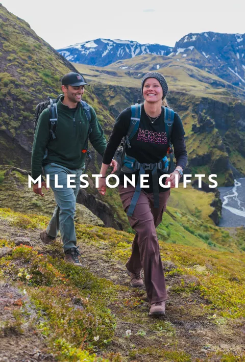Two Backroads guests on a hike with copy overlay &quot;milestone gifts&quot;
