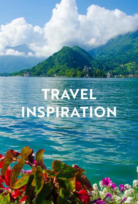 Blue water with mountain in the background with text overlay "Travel Inspiration"