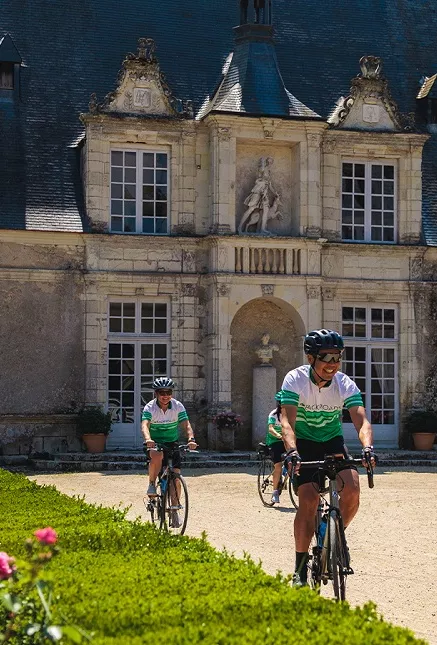 Group of bikers riding in front of a cathedral building