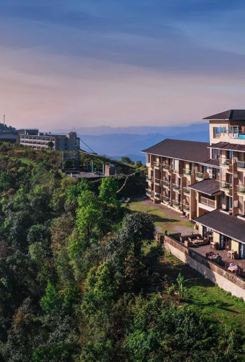 Hotel on top of a mountain with mountains in the distance
