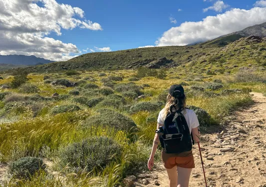 A woman hiking on a dirt path