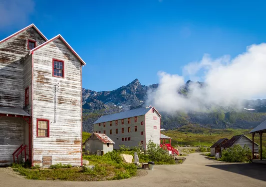 Wood sided buildings next to a mountain in Alaska
