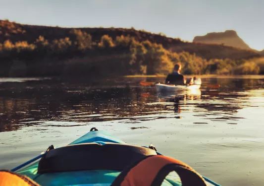 POV shot of kayaking guest, sunset.
