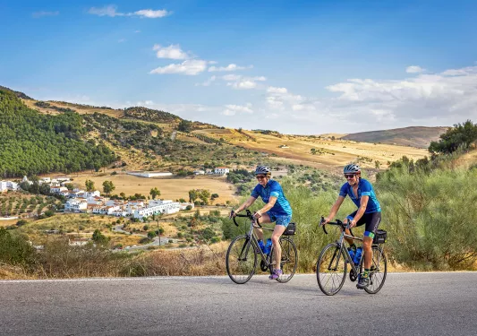 Two bikers riding on a road in southern Spain.