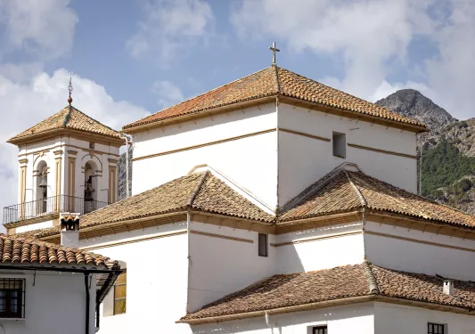 White Spanish buildings with red tile roofs.
