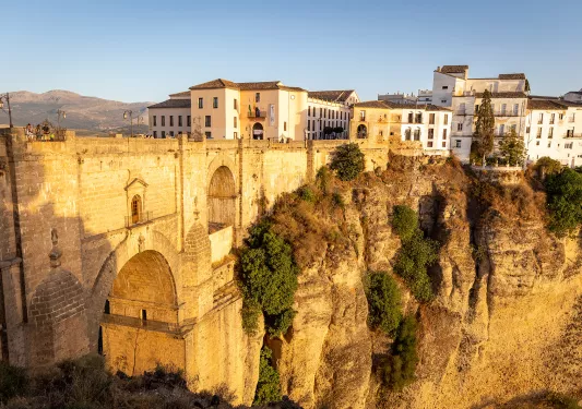 Spanish buildings on top of a cliff with dramatic drop.