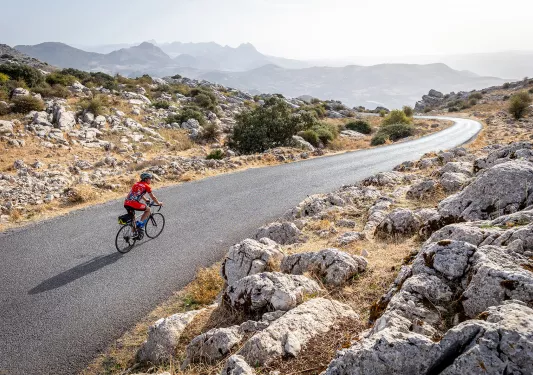 Biker riding on a road in Spain.