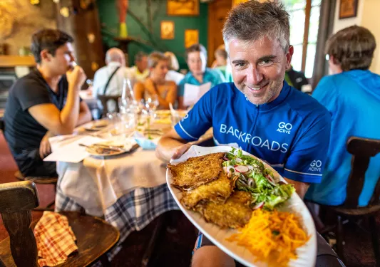 Backroads Guest Showing Off Meal in Alsace