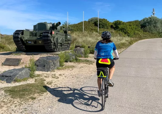 Backroads Guest Biking Past Army tank