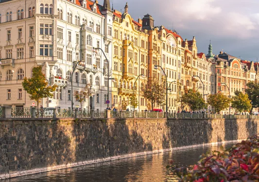 Large ornate apartment buildings along the bank of a river.