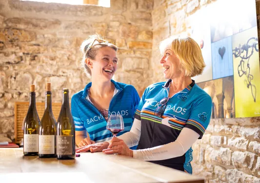 Two Backroads Guests Laughing Over Wine