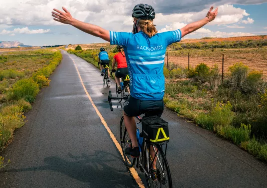 Back shot biker with arms up