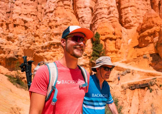 Two hikers hiking among rock formation