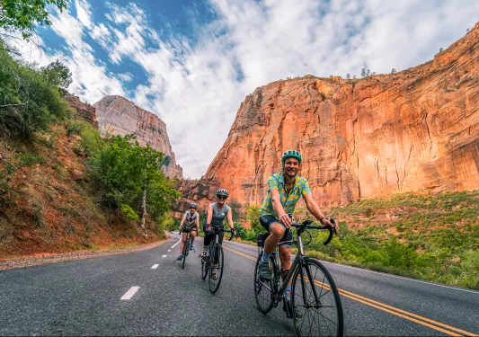 Below eye-level shot of three bikers in canyon