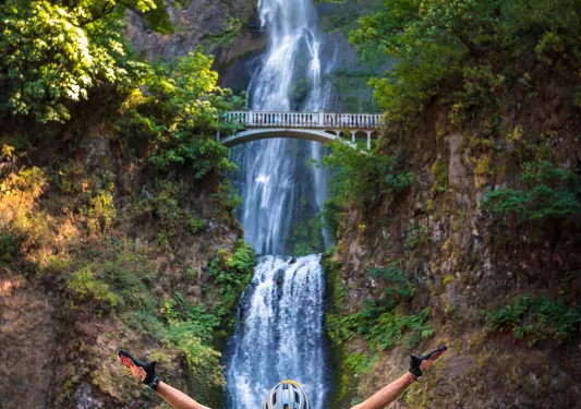 Guest in foreground, Multnomah Falls in background.