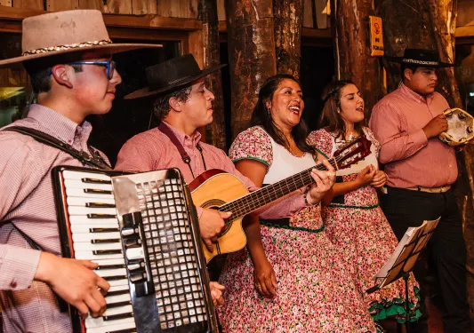 Band playing accordion, guitar and tambourine. 