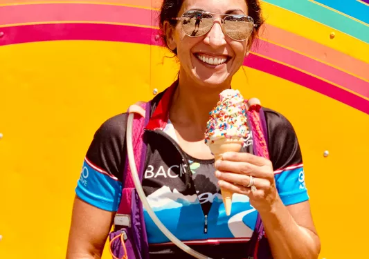 Guest with ice cream standing in front of colorful food-truck.