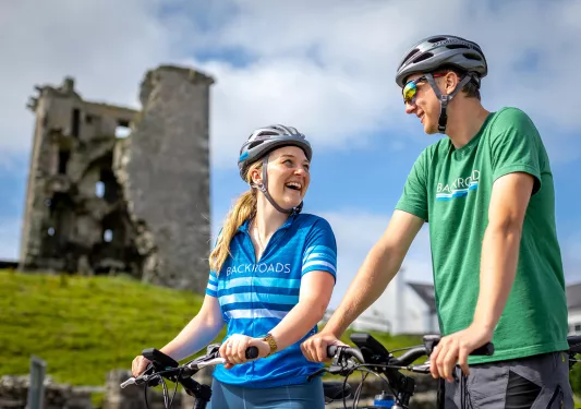 Cyclist In Front of Ruin Ireland