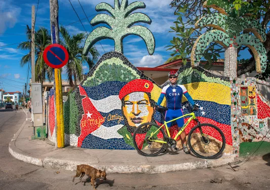Cyclist in Front of Art Work Cuba