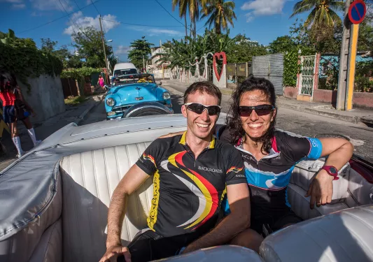 Leaders Riding in the Back of a Classic Car Cuba
