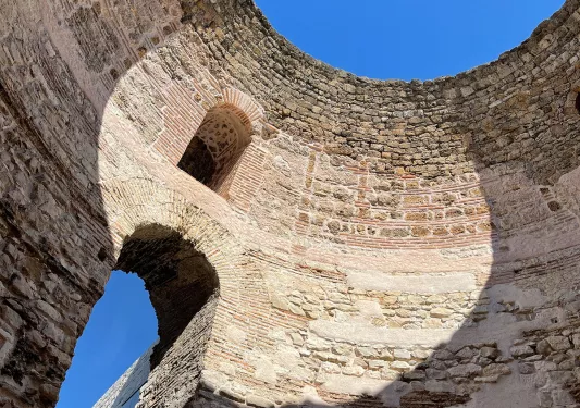 Ground shot of inside of circular brick and stone building.