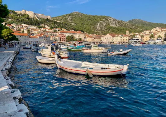 Coastal town and houses, boats scattered about.
