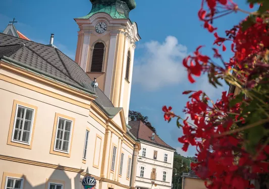 Two people hugging with glass of white wine in Budapest.