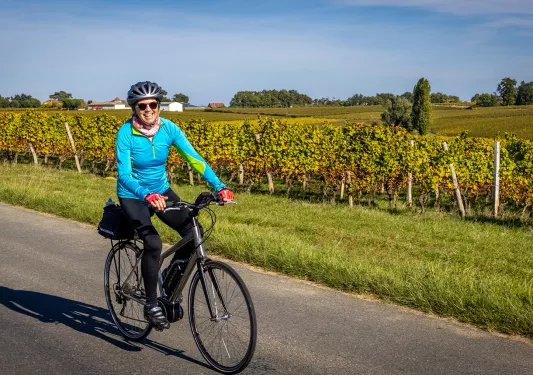 Backroads Guest Biking Past Field