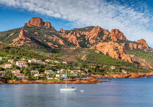 Village And Trees Among Red Rocks of Esterel Massif During Sunny Day-French Riviera, Provence-Alpes, Cote d'Azur, France