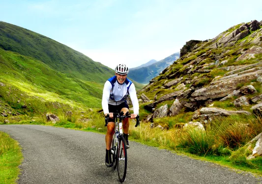 Cyclist Riding Up Hill Ireland