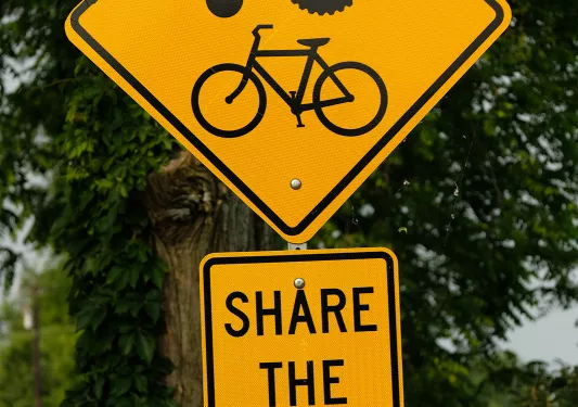 Close-up of "Share the Road" showing cyclist and tractor.