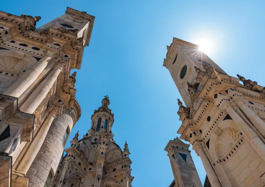 Ground shot looking up at the Château de Chambord spires.
