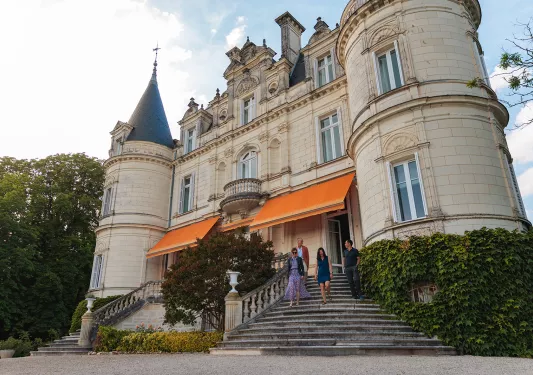 Storefront shot of the Domaine de la Tortinière, guests leaving.