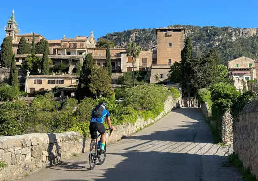 Biker riding across a bridge in Spain.