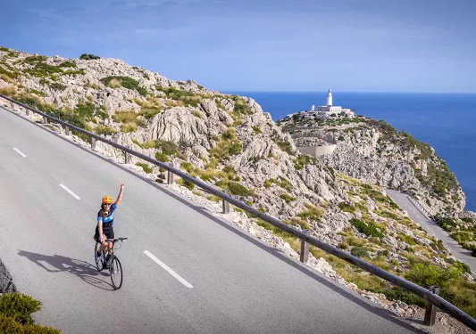 Biker riding on a road on the coast of Mallorca.