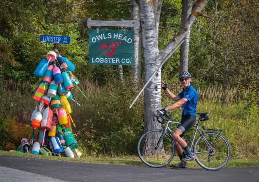 Guest pointing to a sign reading "OWL'S HEAD LOBSTER CO.".