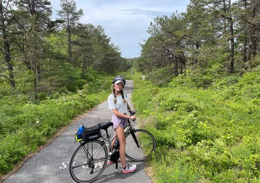 Young guest on small backroad with bike.