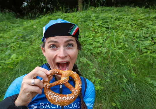 Backroads leader posing with soft pretzel.