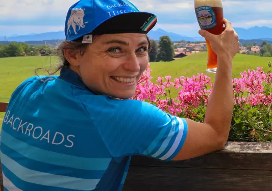 Backroads leader posing with pint of beer.