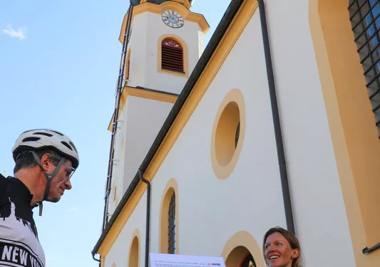 Biker showing another biker a map of the trip route.