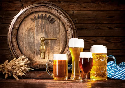 Mugs of beer in different types of glasses.